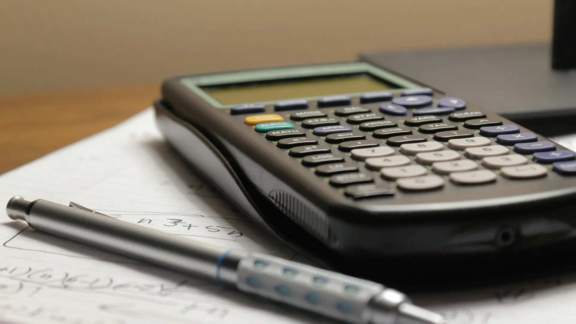A calculator and a pen on paper