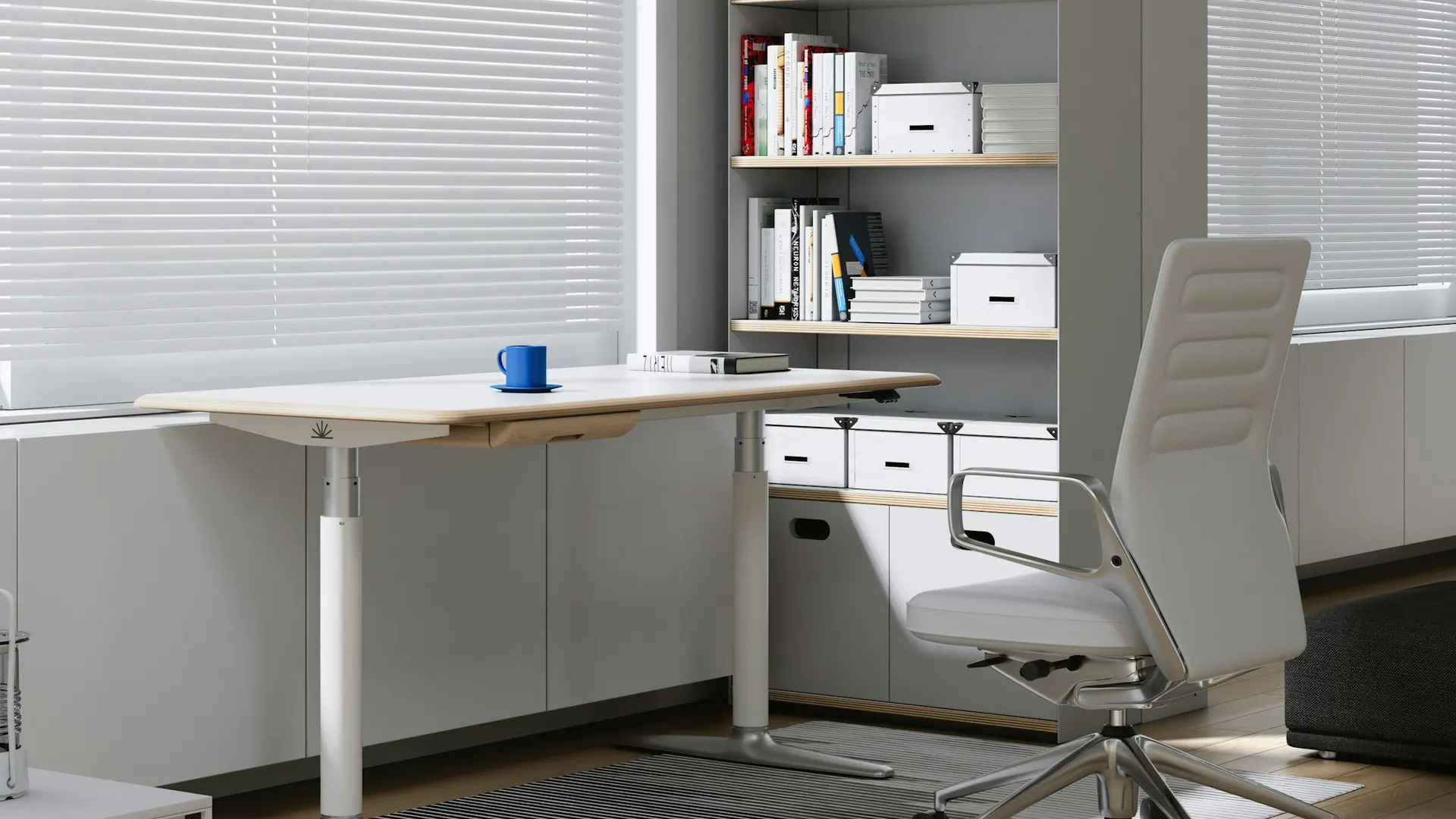 An empty desk and office chair by a window